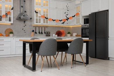 Photo of Stylish kitchen interior with festive decor. Halloween celebration