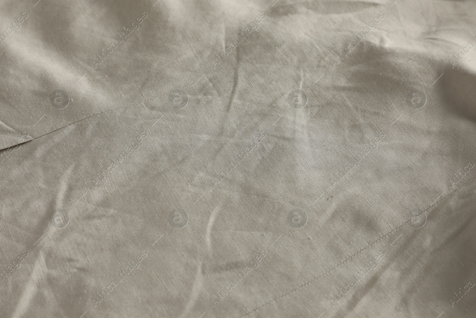 Photo of Crumpled dark beige fabric as background, closeup view