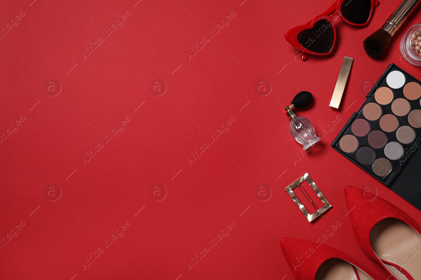 Photo of Flat lay composition with stylish women's shoes and different makeup products on red background. Space for text