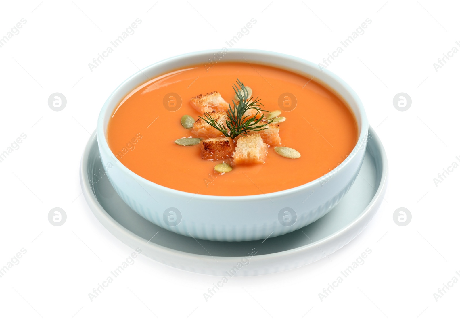Photo of Tasty creamy pumpkin soup with croutons, seeds and dill in bowl on white background