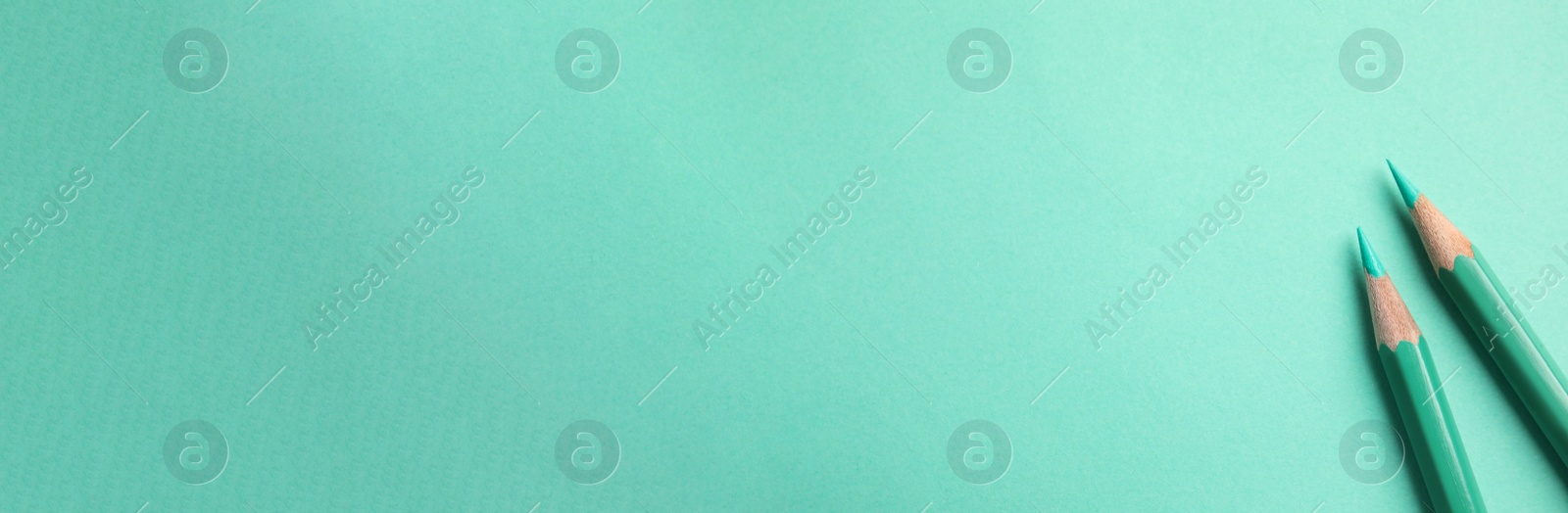 Image of Color pencils on turquoise background, flat lay with space for text. Banner design