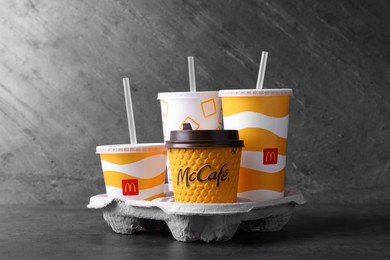 MYKOLAIV, UKRAINE - AUGUST 12, 2021: Cold and hot McDonald's drinks on grey table