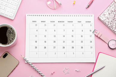 Photo of Flat lay composition with calendar on pink background