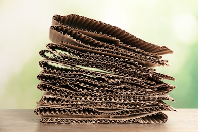 Stack of cardboard for recycling on table against blurred background