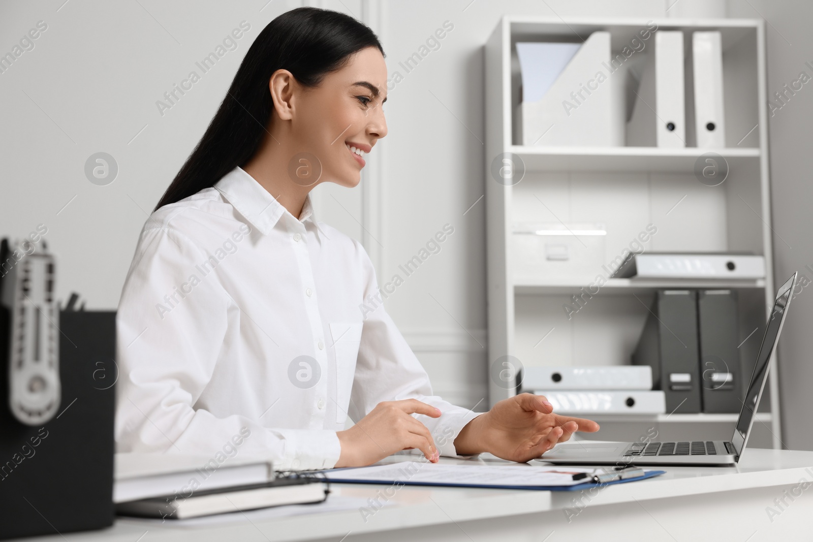 Photo of Human resources manager conducting online job interview via video chat on laptop