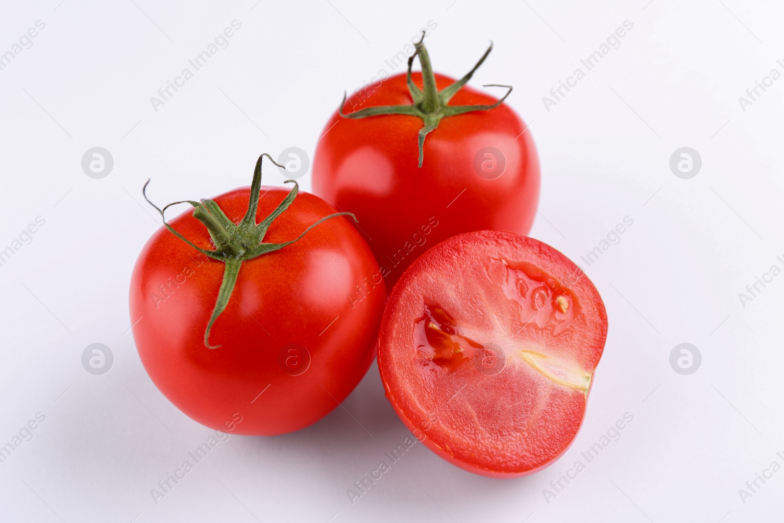 Photo of Whole and ripe red tomatoes on white background