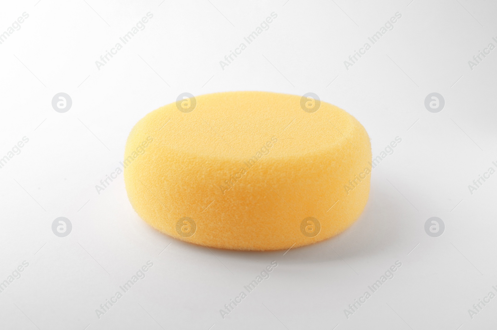 Photo of Yellow sponge for clay modeling on white background