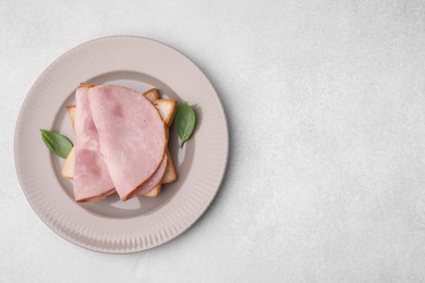 Photo of Delicious sandwich with ham on light table, top view. Space for text