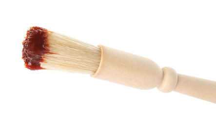 Photo of Basting brush with barbecue sauce on white background