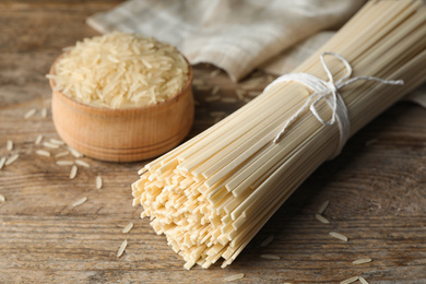 Photo of Raw rice noodles on wooden table, closeup