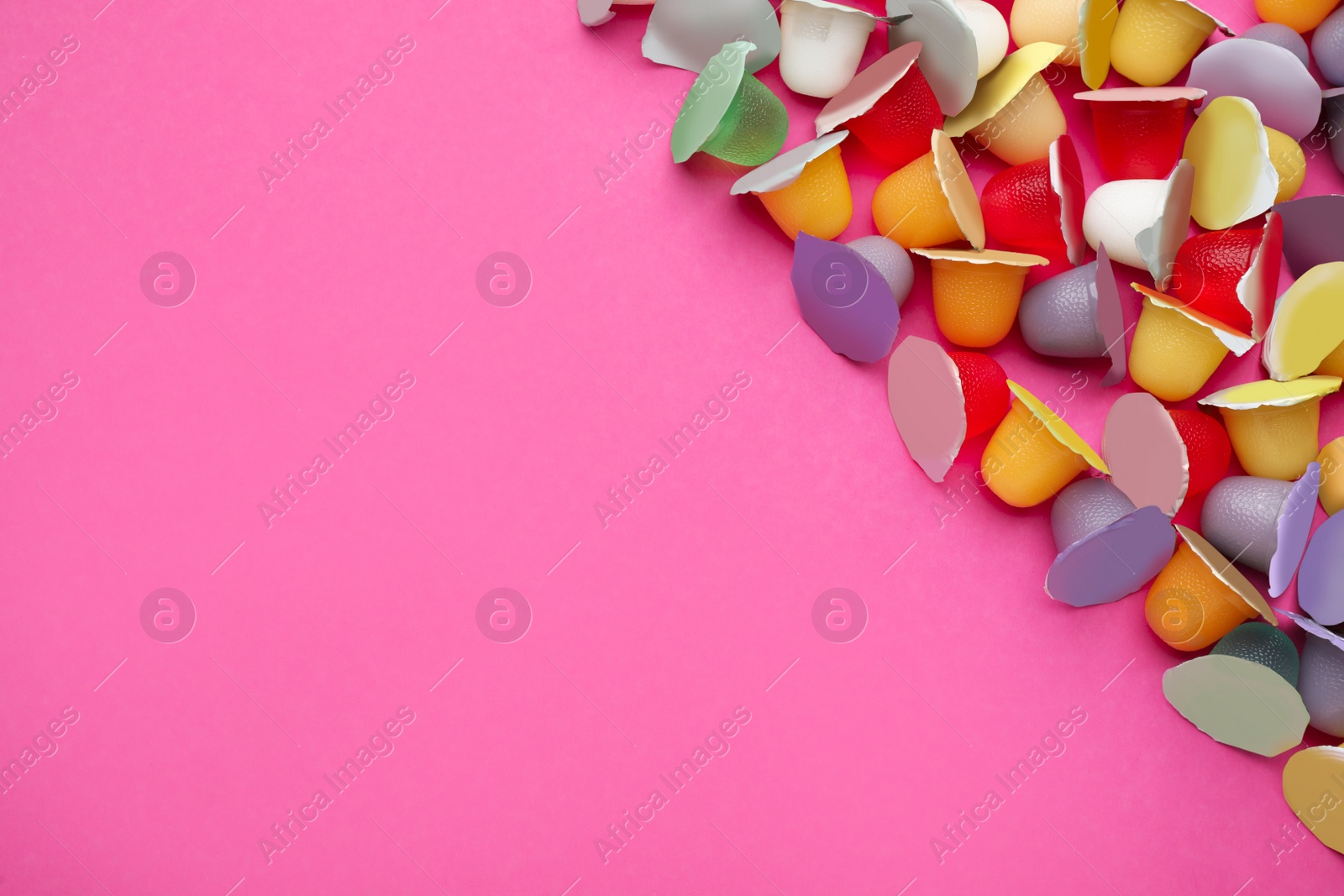 Photo of Tasty bright jelly cups on pink background, flat lay. Space for text