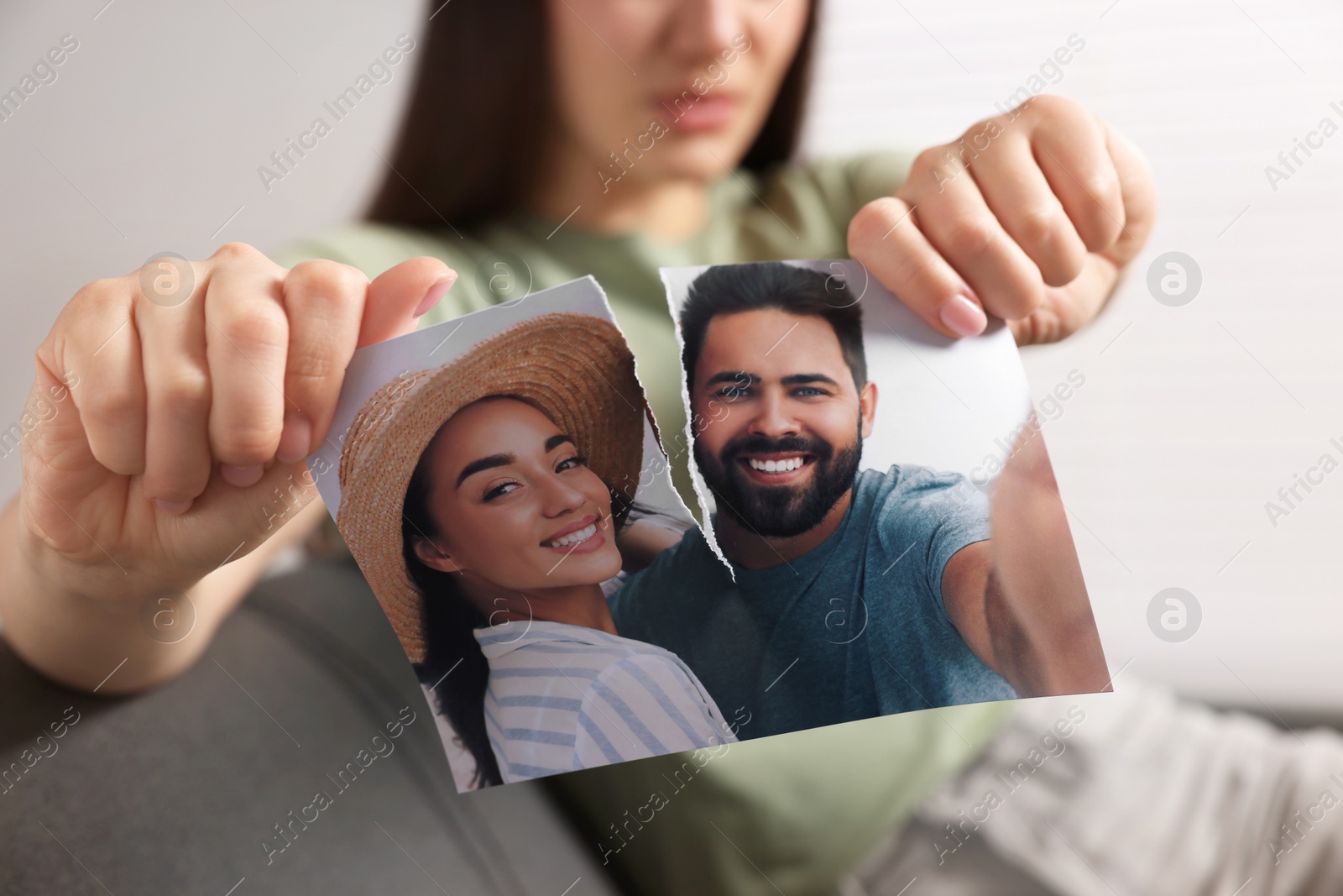 Photo of Woman ripping photo indoors, closeup. Divorce concept