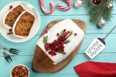 Flat lay composition with traditional classic Christmas cake on turquoise wooden table