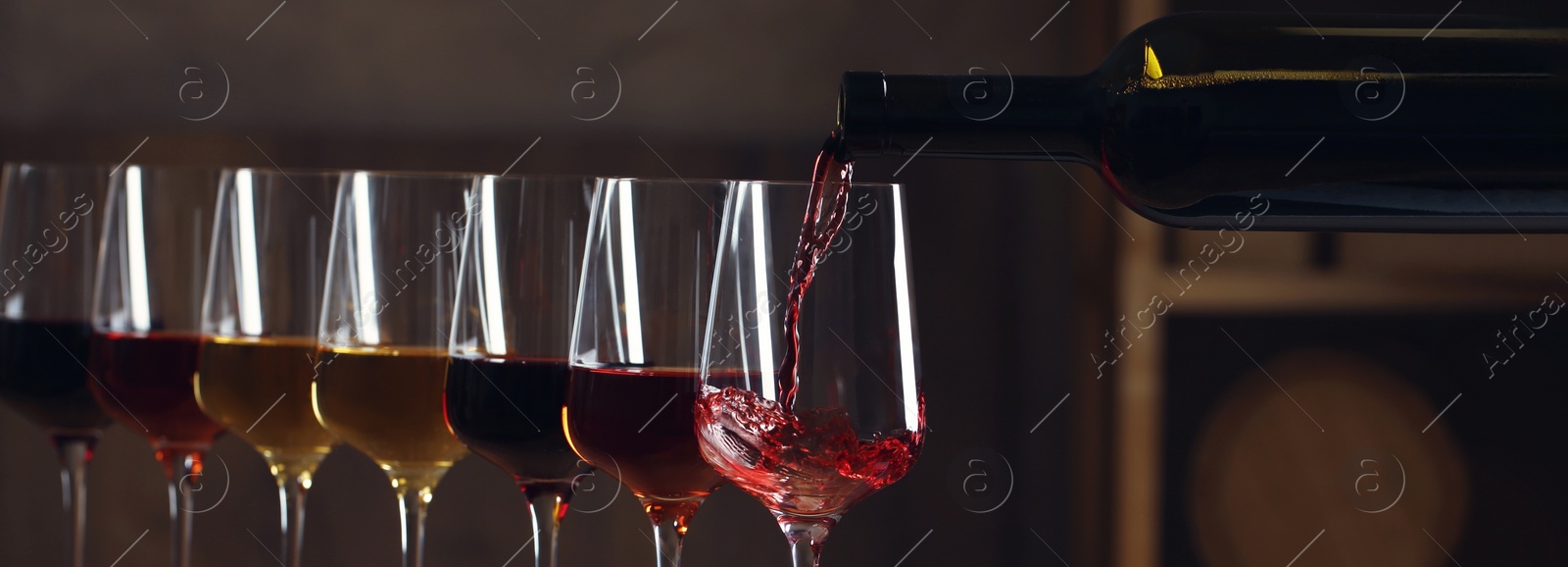 Image of Pouring wine from bottle into glass. Banner design