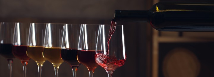 Pouring wine from bottle into glass. Banner design