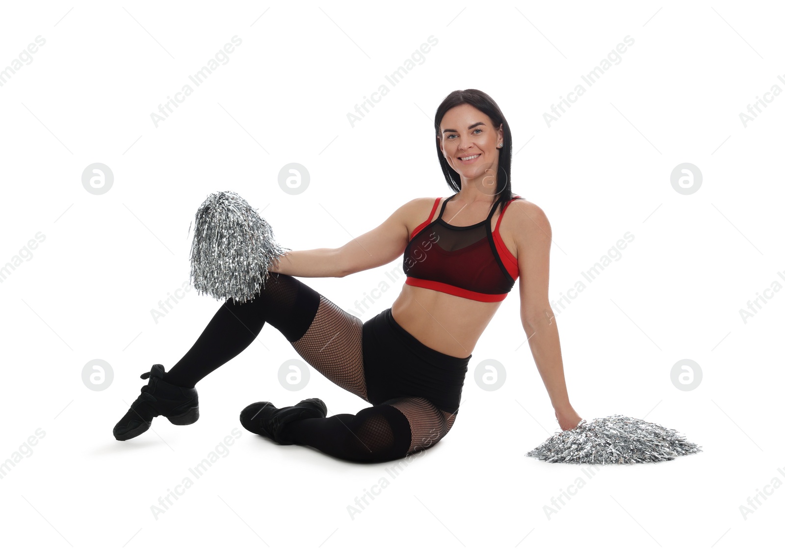 Photo of Beautiful cheerleader in costume holding pom poms on white background