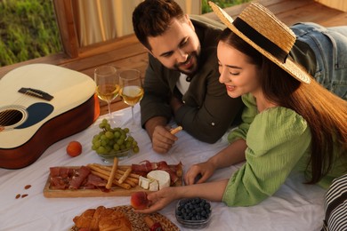 Photo of Romantic date. Beautiful couple having picnic outdoors