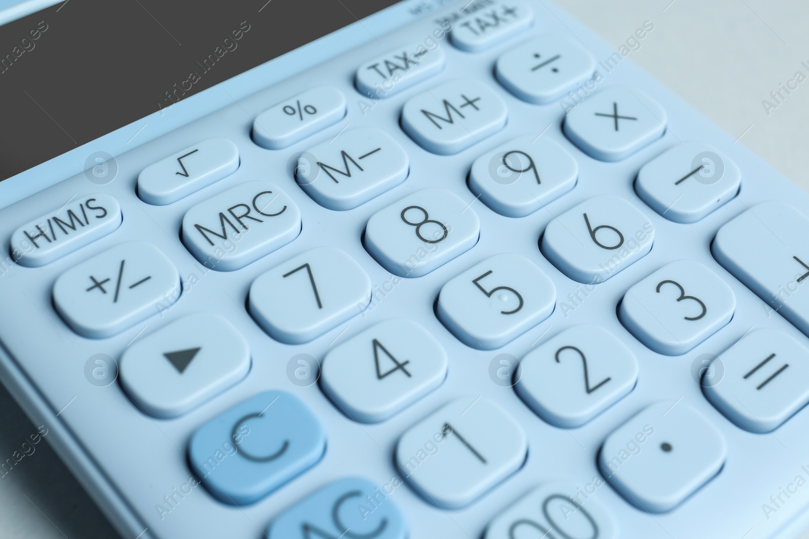 Photo of Closeup view of white calculator on light background