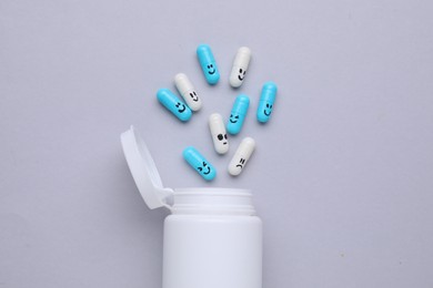 Photo of Antidepressants and medical bottle on grey background, flat lay