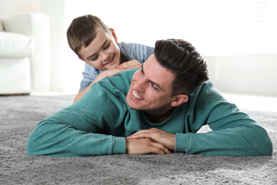 Dad and son spending time together at home. Happy Father's Day