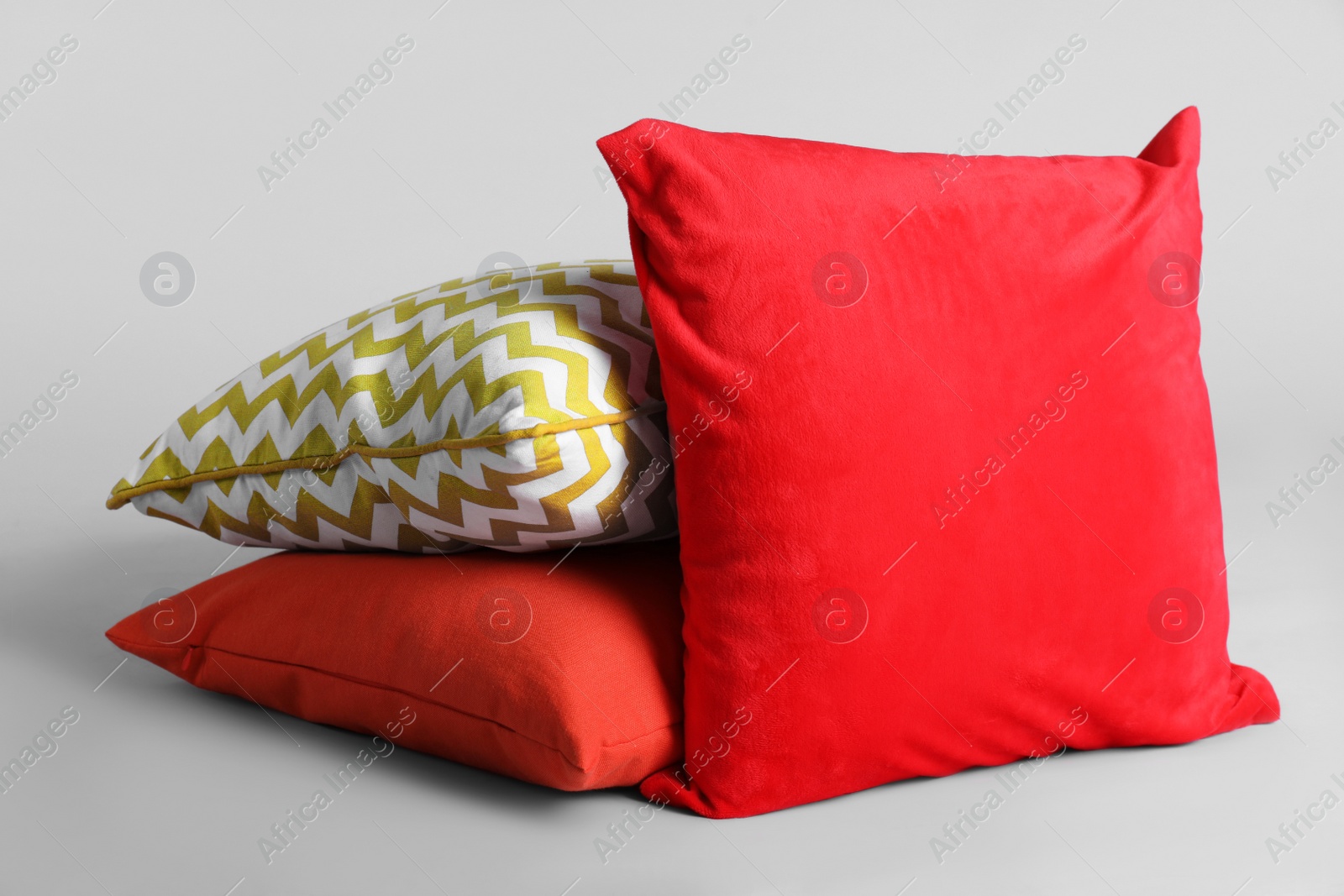 Photo of Different stylish soft pillows on grey background