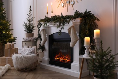 Photo of Stylish room interior with fireplace and beautiful Christmas decor