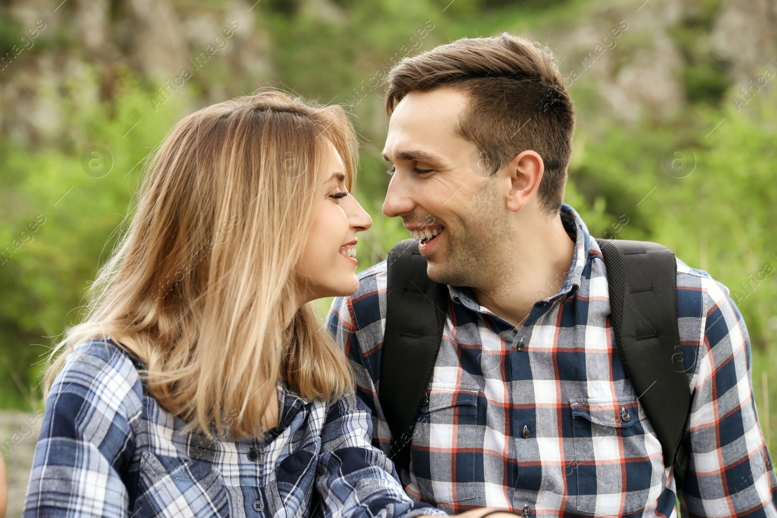 Photo of Young man with his girlfriend outdoors. Camping season