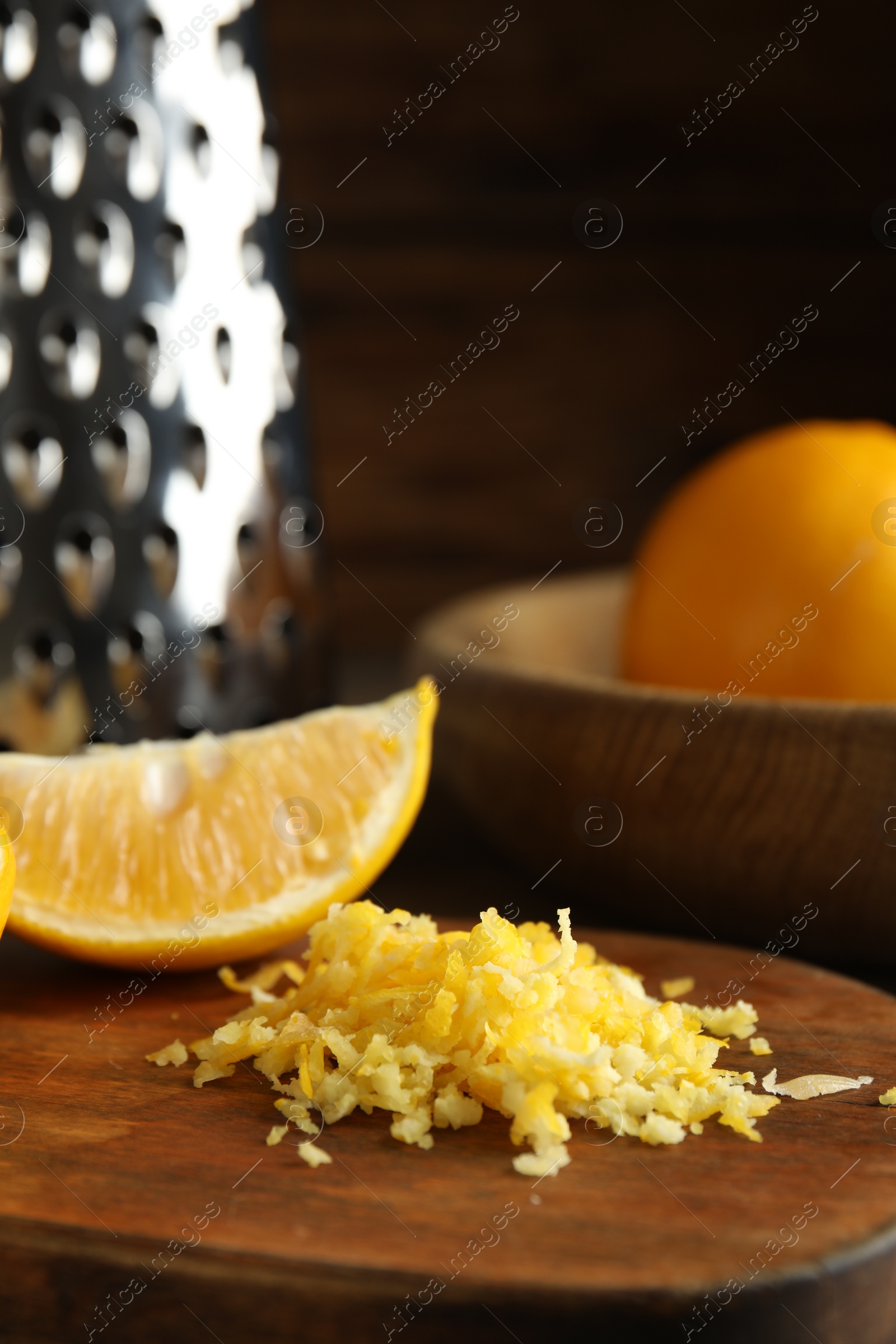 Photo of Lemon zest and fresh fruits on wooden board, closeup