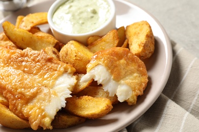 Photo of Plate with British Traditional Fish and potato chips on grey background, closeup