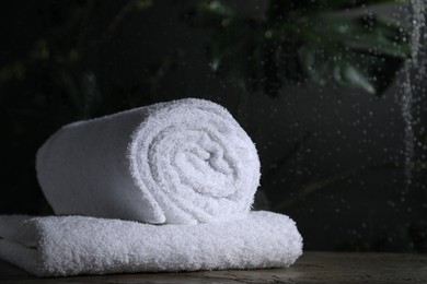 White terry towels on table in bathroom, space for text