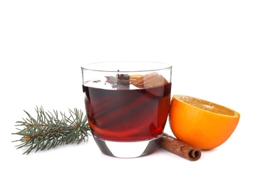 Photo of Glass of mulled wine with fir branch and orange isolated on white