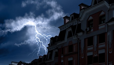Image of Dark cloudy sky with lightning over building. Stormy weather