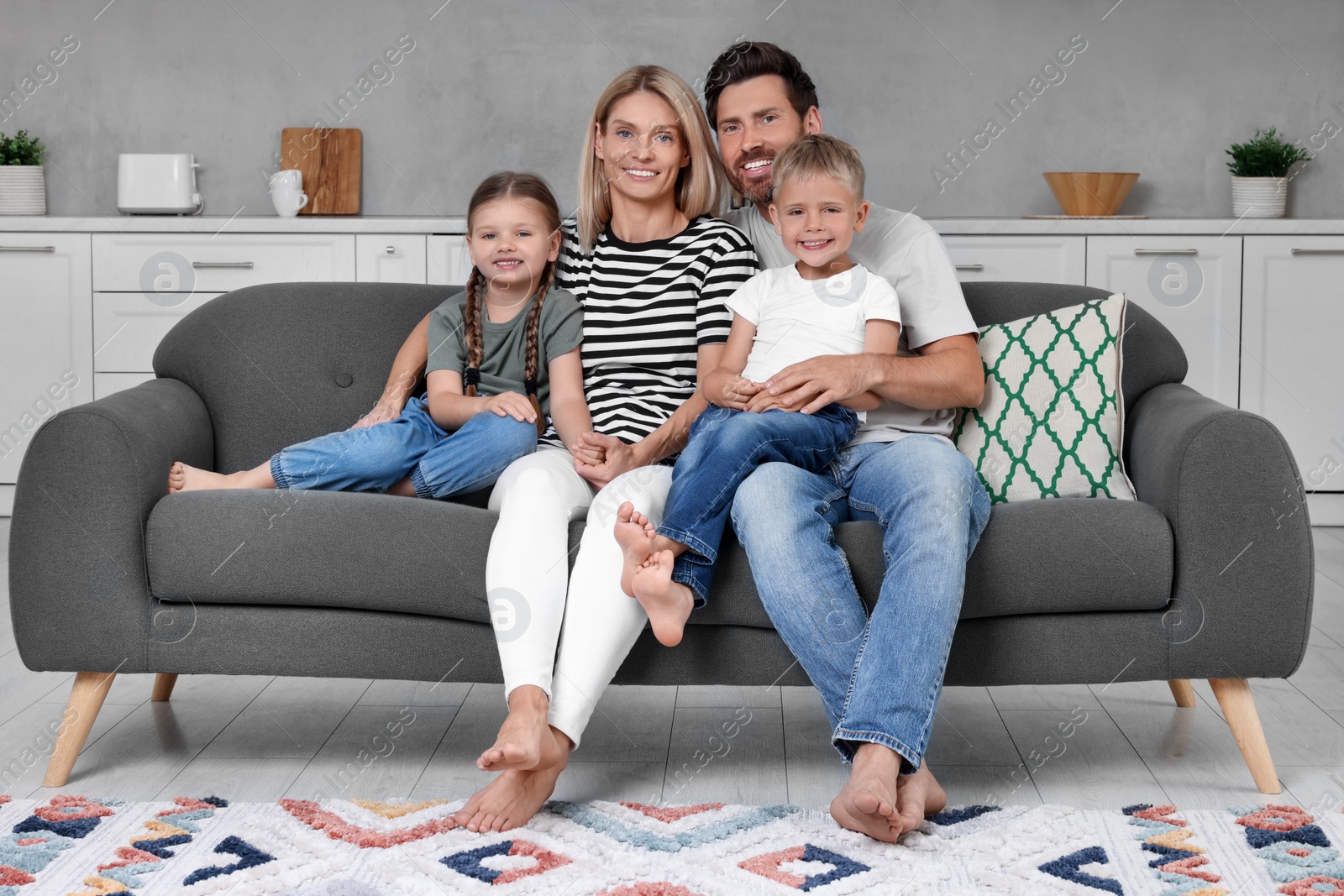 Photo of Portrait of happy family with children on sofa at home