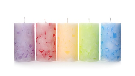 Five color wax candles on white background