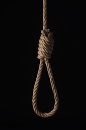 Photo of Rope noose with knot on black background