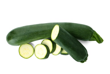 Photo of Cut and whole green ripe zucchini isolated on white, top view