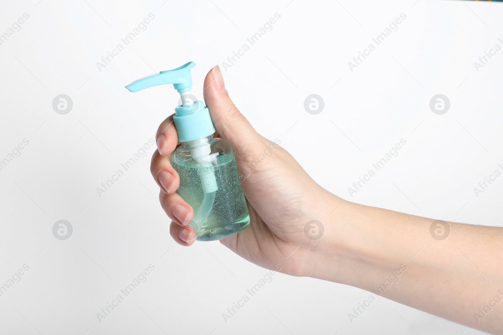 Photo of Woman holding antiseptic gel on white background, closeup