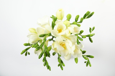 Photo of Bouquet of fresh freesia flowers isolated on white, top view