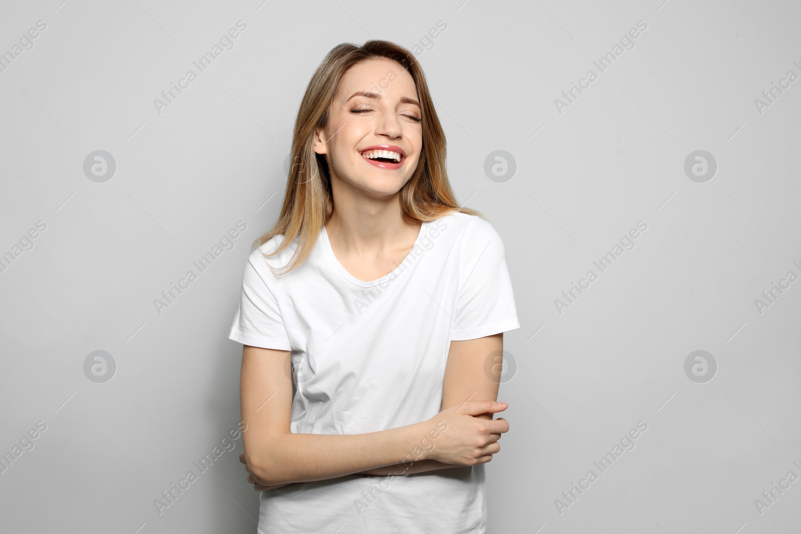 Photo of Portrait of young woman with beautiful face on grey background