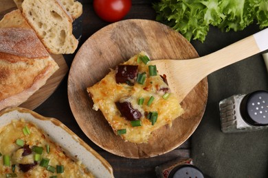 Photo of Tasty sausage casserole served on table, flat lay