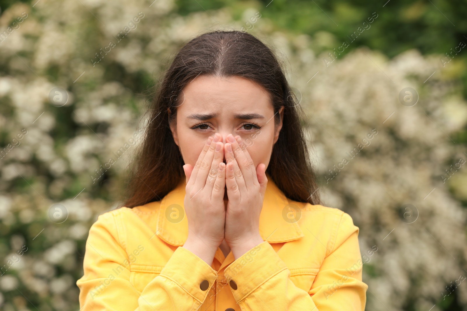 Photo of Woman suffering from seasonal spring allergy outdoors