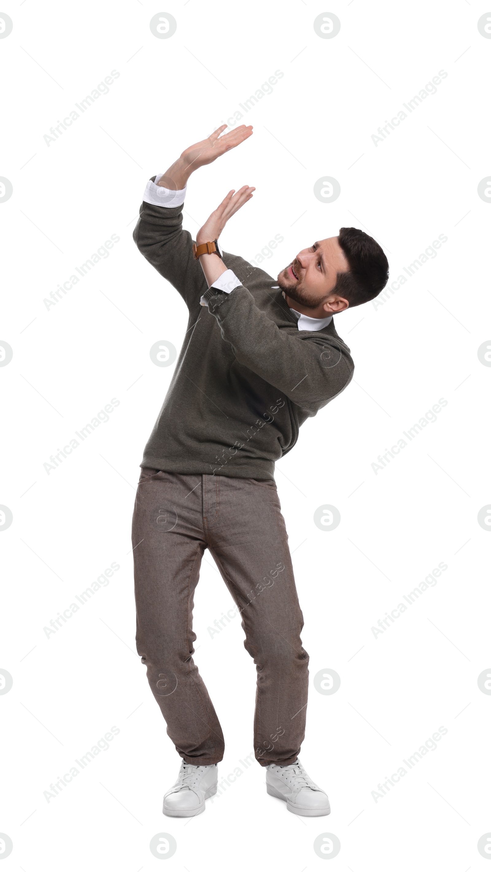 Photo of Handsome bearded businessman evading something on white background