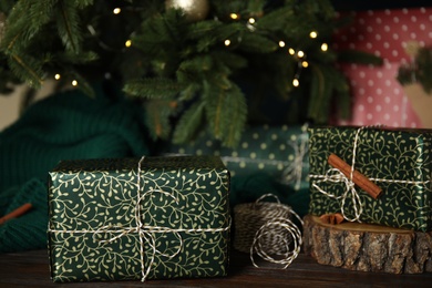 Composition with beautifully wrapped gift boxes on wooden table