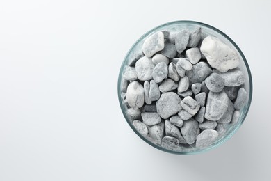 Photo of Presentation for product. Glass container with stones on light grey background, top view. Space for text