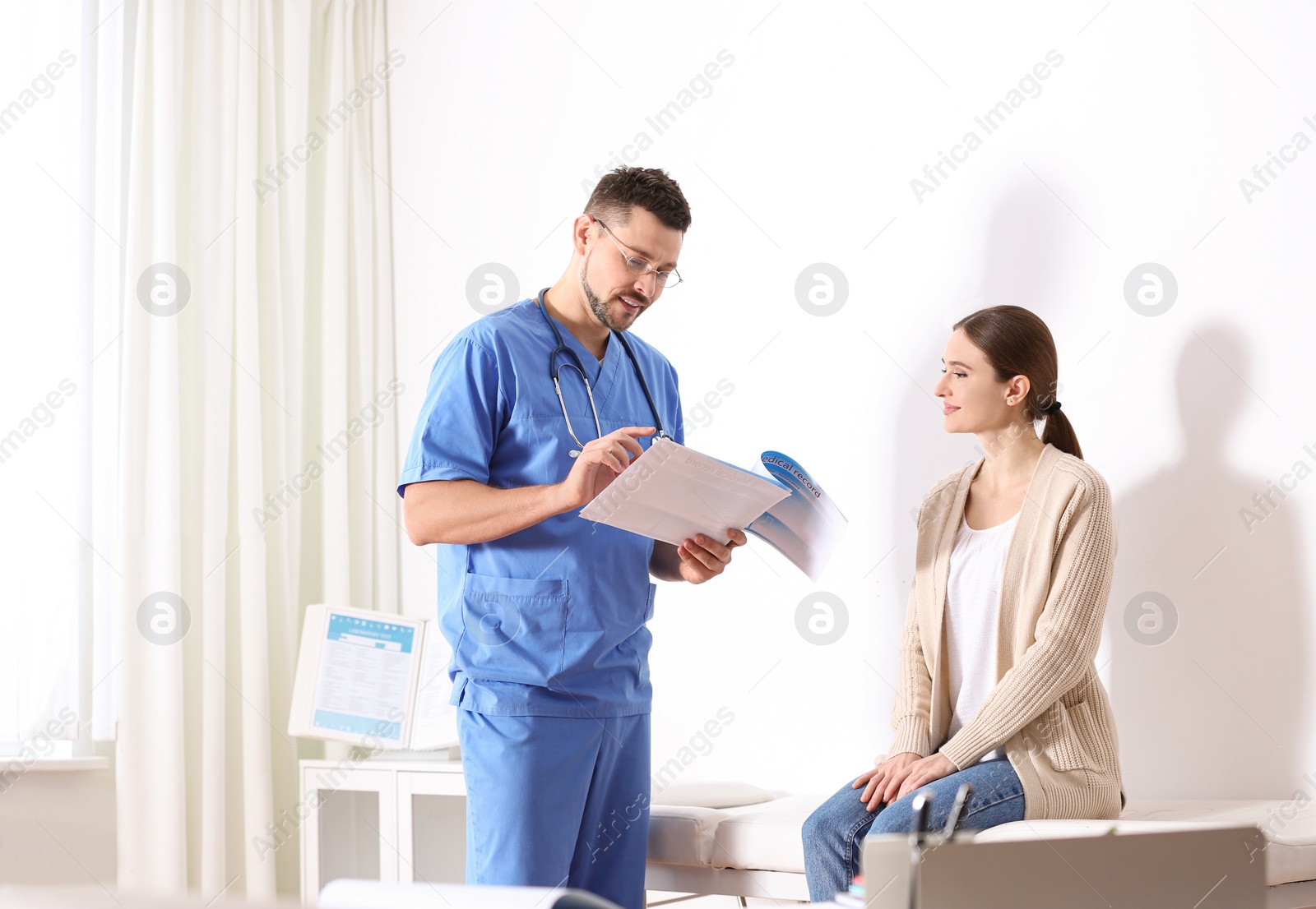 Photo of Doctor consulting patient in his office at hospital