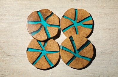 Stylish cup coasters on white wooden table, flat lay