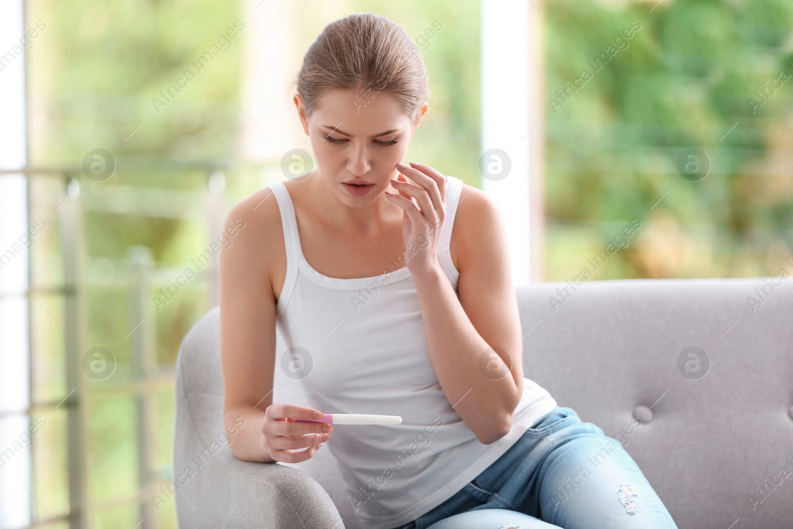 Photo of Young woman with pregnancy test at home. Gynecology