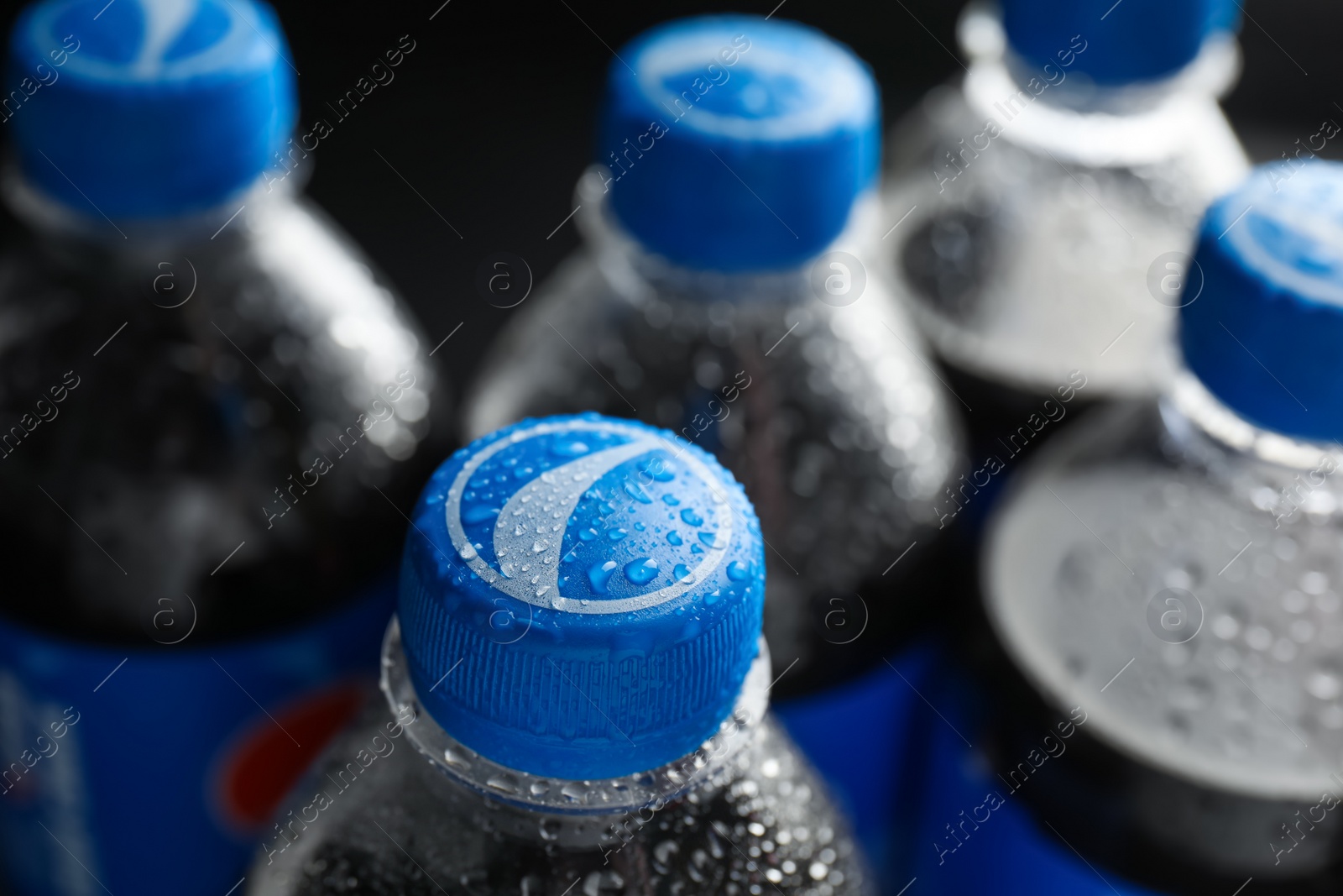 Photo of MYKOLAIV, UKRAINE - FEBRUARY 08, 2021: Plastic bottles of Pepsi with water drops, closeup