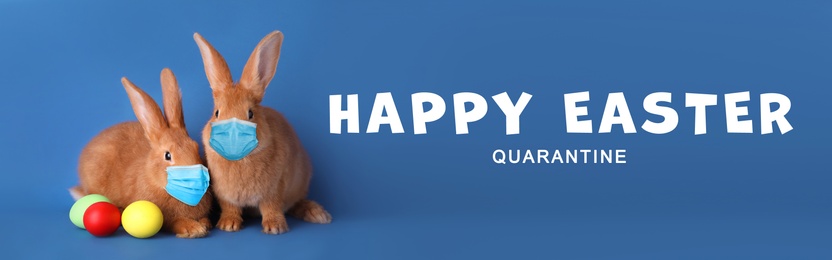 Image of Text Happy Easter Quarantine and cute bunnies in protective masks on blue background, banner design. Holiday during Covid-19 pandemic