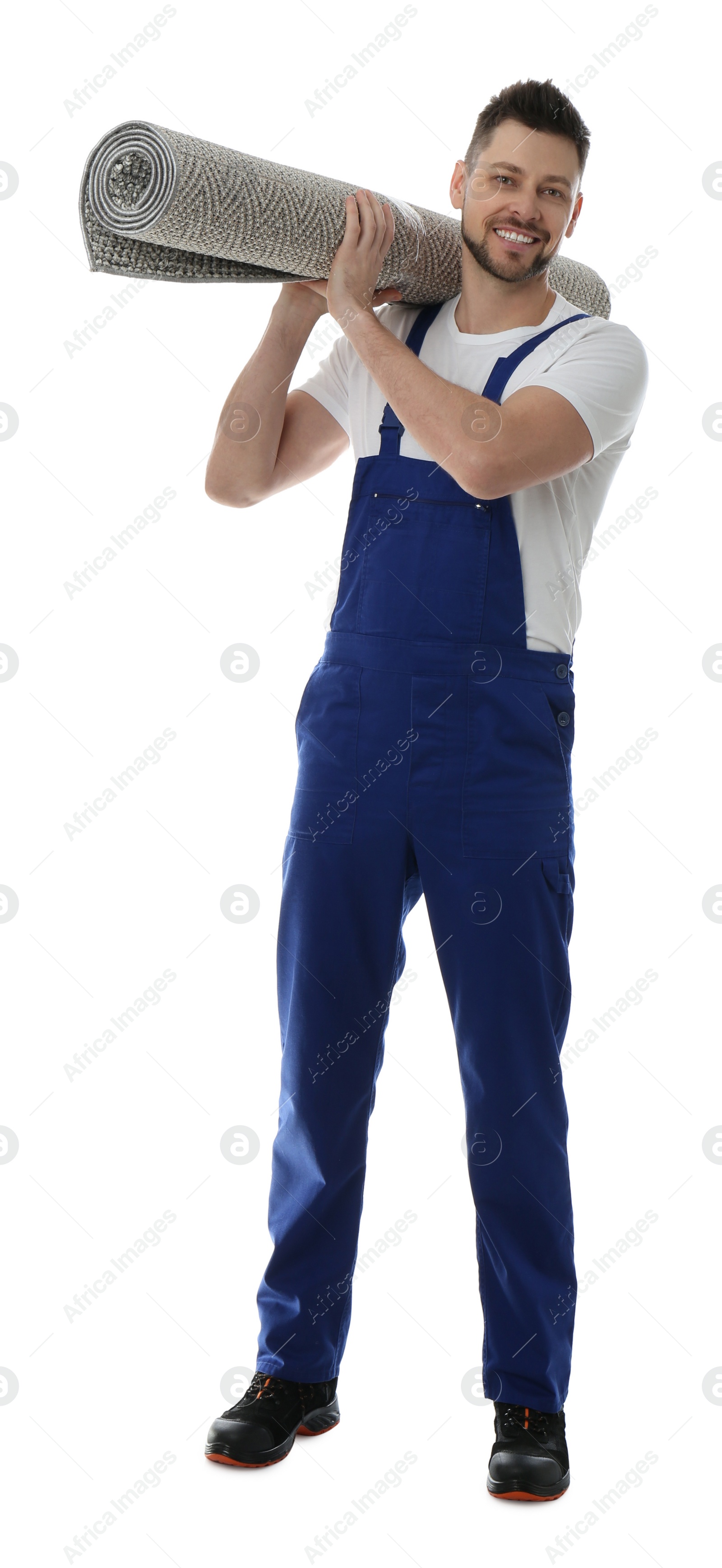 Photo of Male worker with rolled carpet on white background